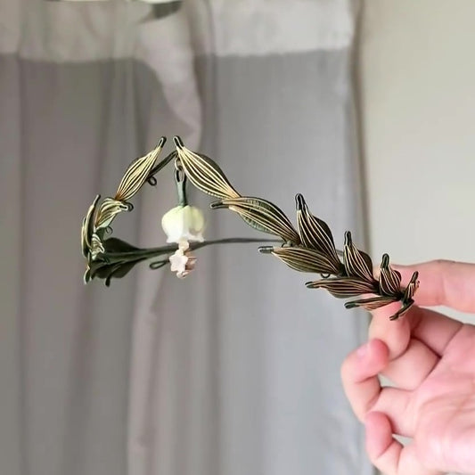3D thread-wrapped laurel headband with a delicate handmade blossom pendant for weddings and formal events.