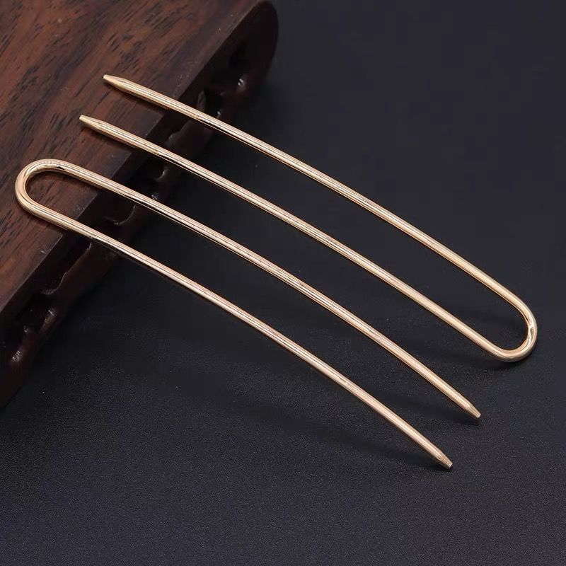 Rose gold U-shaped hair pin with multiple prongs, highlighted on wood block, perfect for custom hair pin projects.