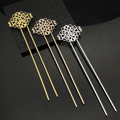 Set of 3 Chinese copper hair sticks 140mm long with ornate floral filigree tops in gold, rose gold and silver finish on black brick background