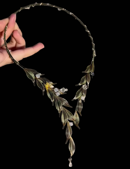 Handmade Chanhua Yingluo necklace with intricate thread-wrapped leaves and sparkling crystal accents.