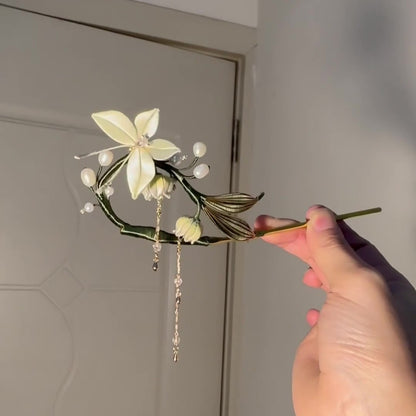Handcrafted Chanhua hairpin featuring a white thread-wrapped butterfly and Lily of the Valley flowers with blue accents.
