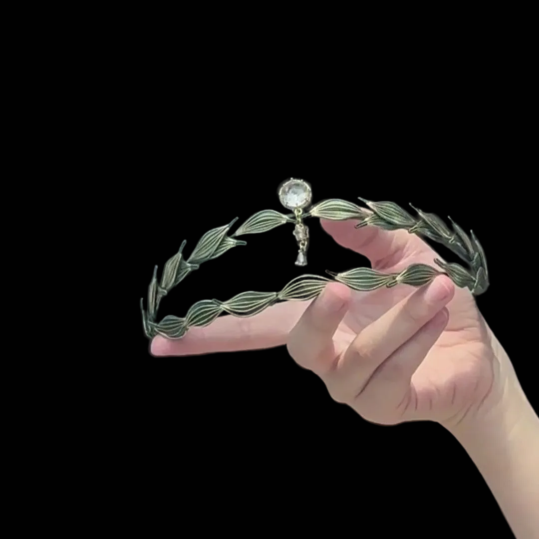 Handcrafted Athena Chanhua crown featuring green thread-wrapped laurel leaves and a central crystal pendant.