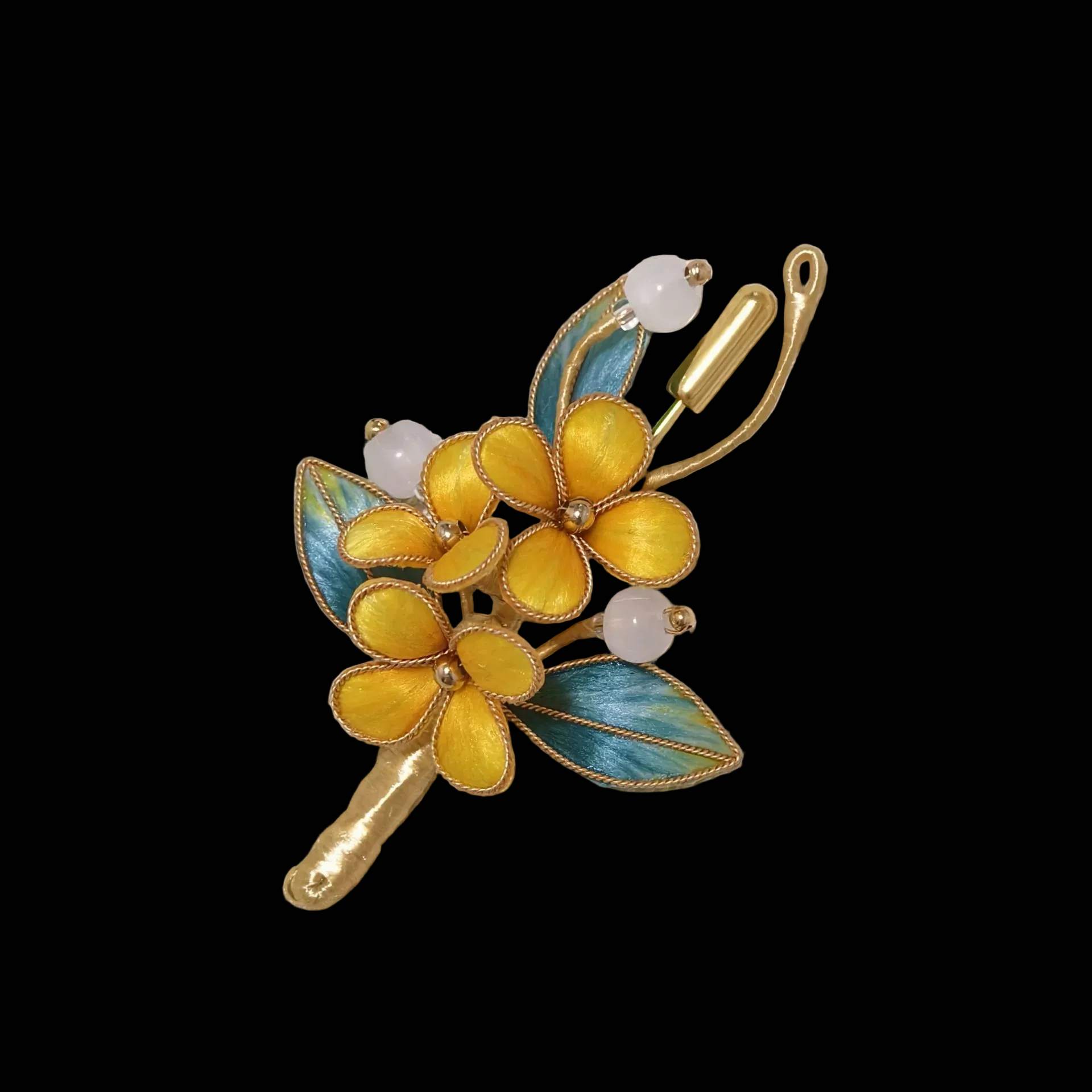 Handmade Ronghua brooch featuring three vibrant yellow silk velvet flowers with gold-toned edges, teal-green leaves, and white beads pinned on textured off-white fabric.