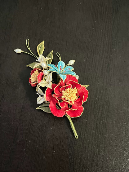 A handmade Chanhua hairpin and brooch with red flowers, green leaves, white flowers, a blue butterfly, and pearls