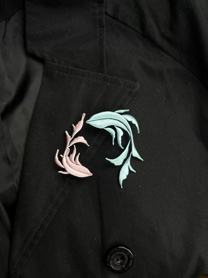 A handmade Chanhua Qiyu little fish brooch on a black coat-4