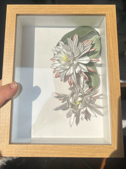 A handmade Chanhua table display in a wooden box with white and pink petals and green leaves-5