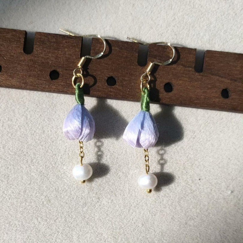 3D silk velvet floral earrings featuring purple buds and green stems, made using traditional artisanal Ronghua techniques.