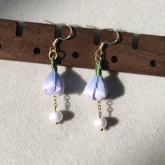3D silk velvet floral earrings featuring purple buds and green stems, made using traditional artisanal Ronghua techniques.