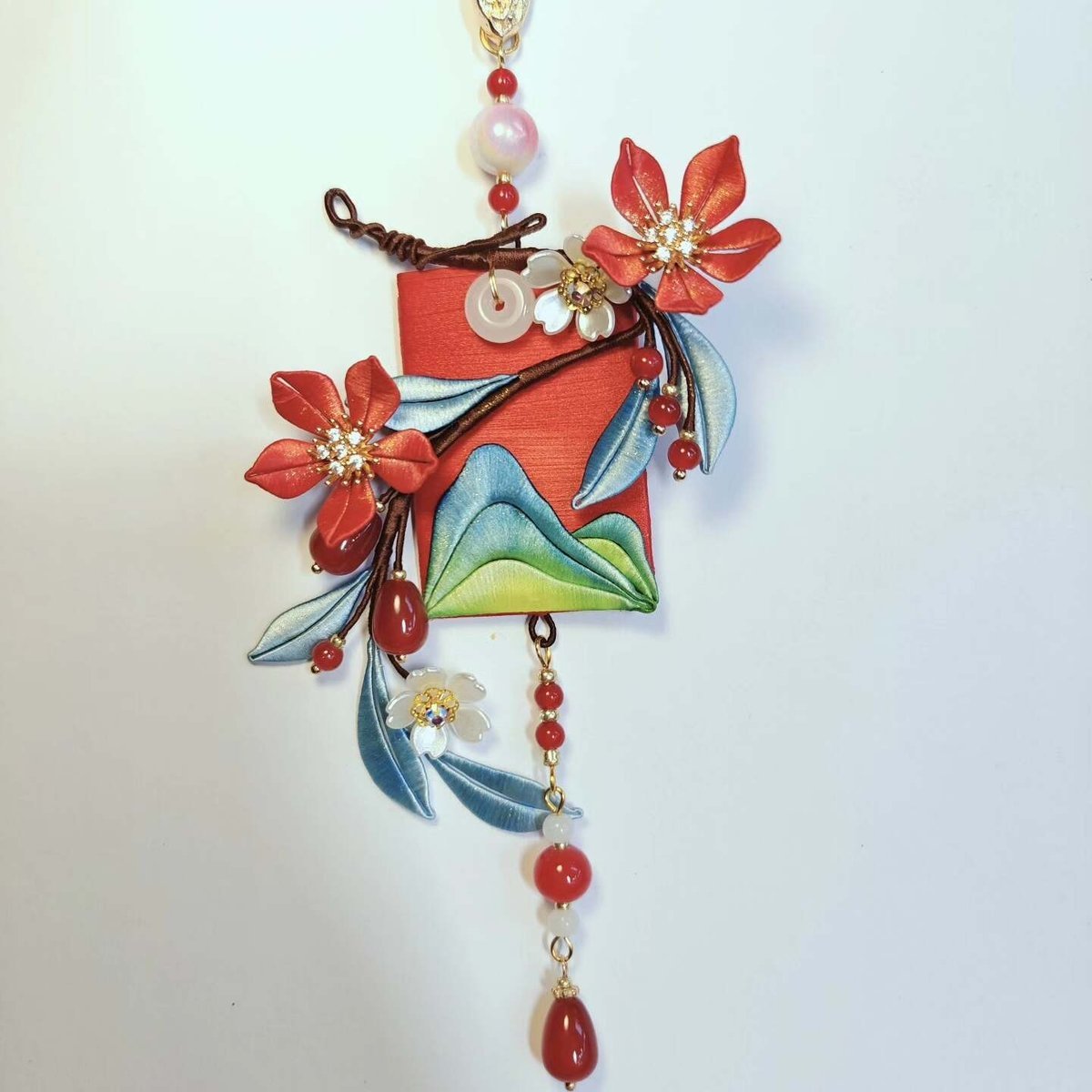 Handcrafted Chanhua hanging ornament featuring thread-wrapped red flowers and a green mountain landscape design.