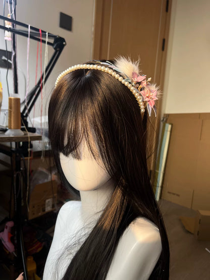 A handmade Chanhua orchid headband with pink flowers, white feathers, and pearls on a mannequin's head-5