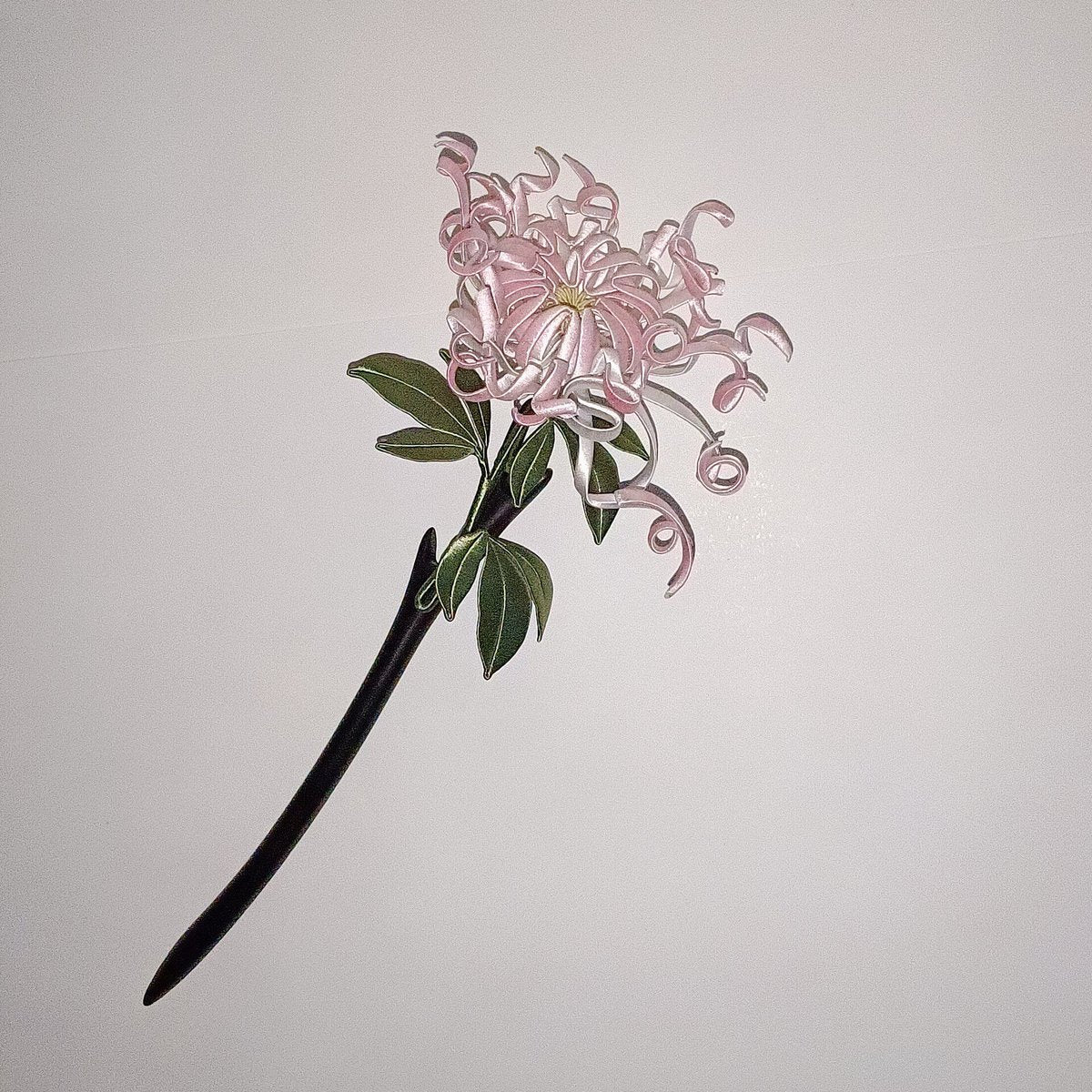 Handcrafted Chanhua thread-wrapped hairpin featuring a large pink chrysanthemum with intricate curled petals and green leaves on a white background.