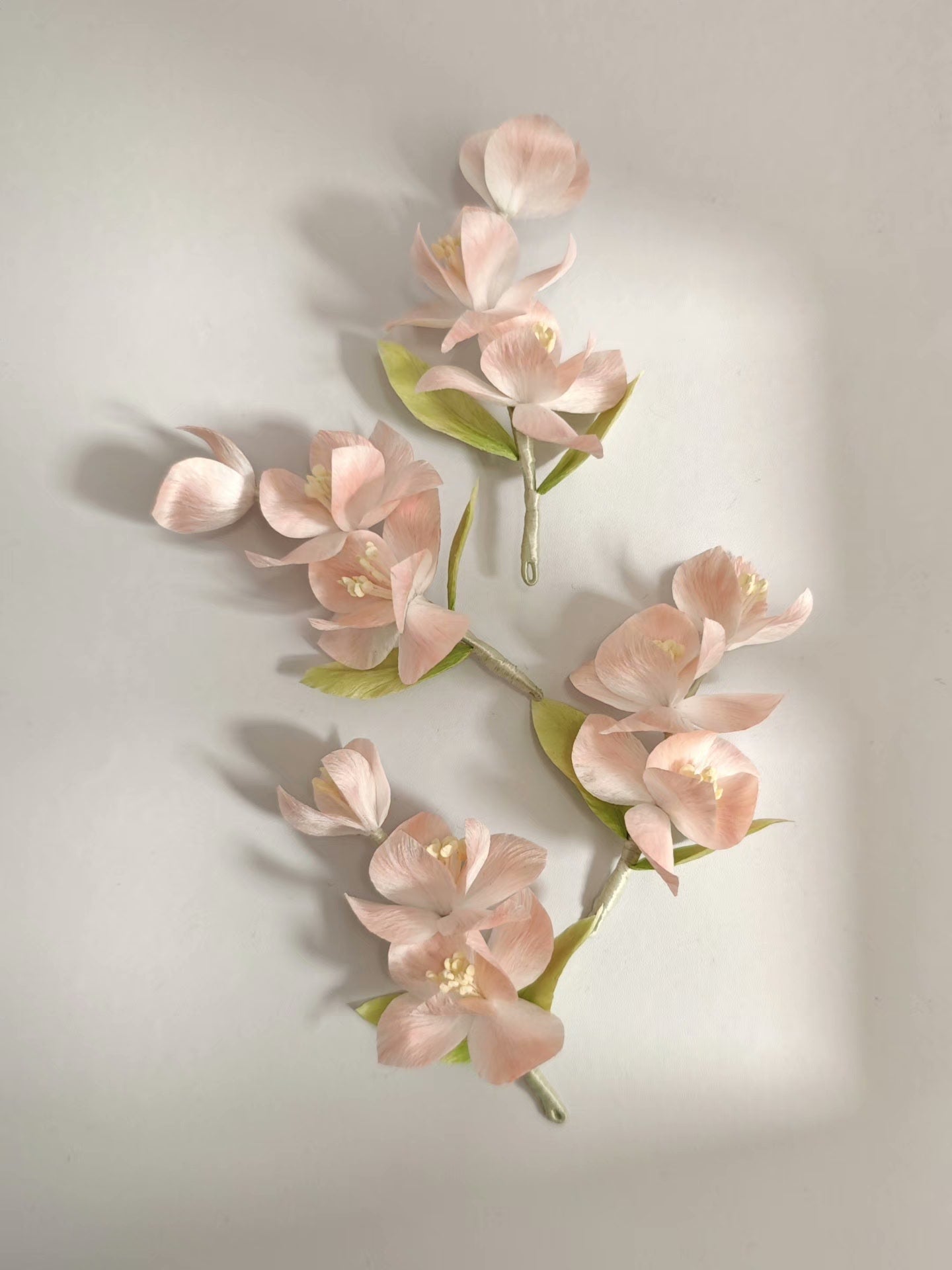 Handmade Ronghua pink iris hair accessory with multiple flowers and green leaves