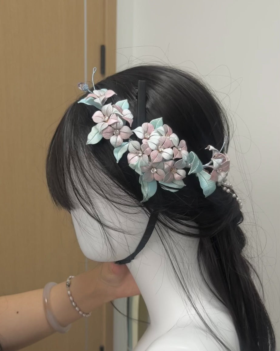 A black graduation cap adorned with handmade Chanhua hydrangea, butterfly, and a lavender bow-3