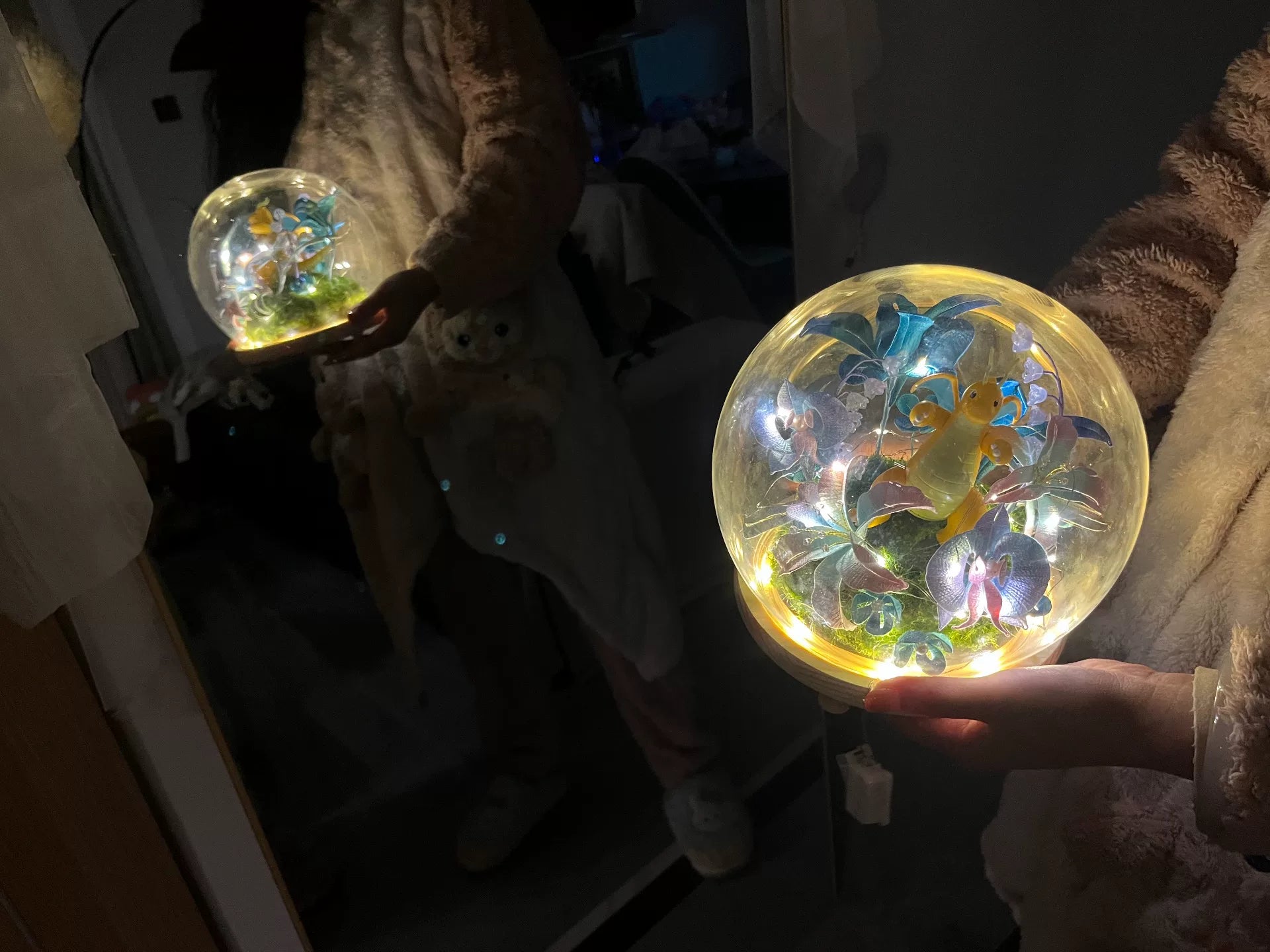 A person holding a handmade Chanhua DIY ornament with illuminated interior