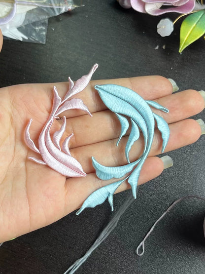 A handmade Chanhua Qiyu little fish brooch on a black coat-2