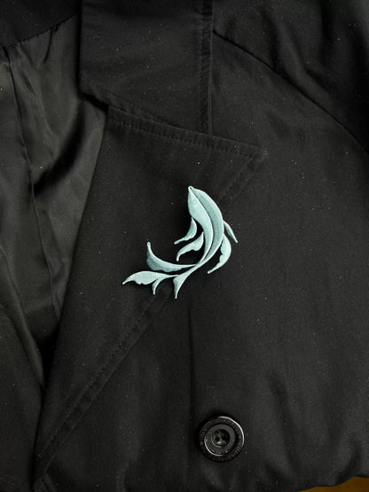A handmade Chanhua Qiyu little fish brooch on a black coat-5