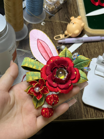 A pair of handmade Chanhua Christmas - style bunny - ear hair clips with red flowers and green leaves, on a mannequin's head-3