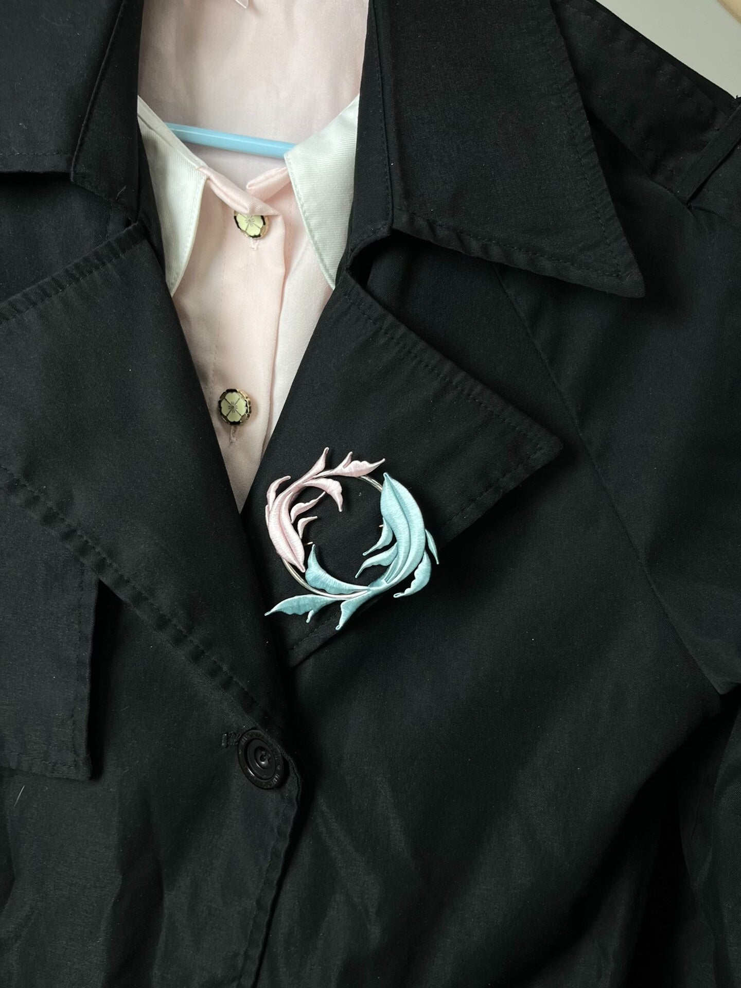 A handmade Chanhua Qiyu little fish brooch on a black coat-6