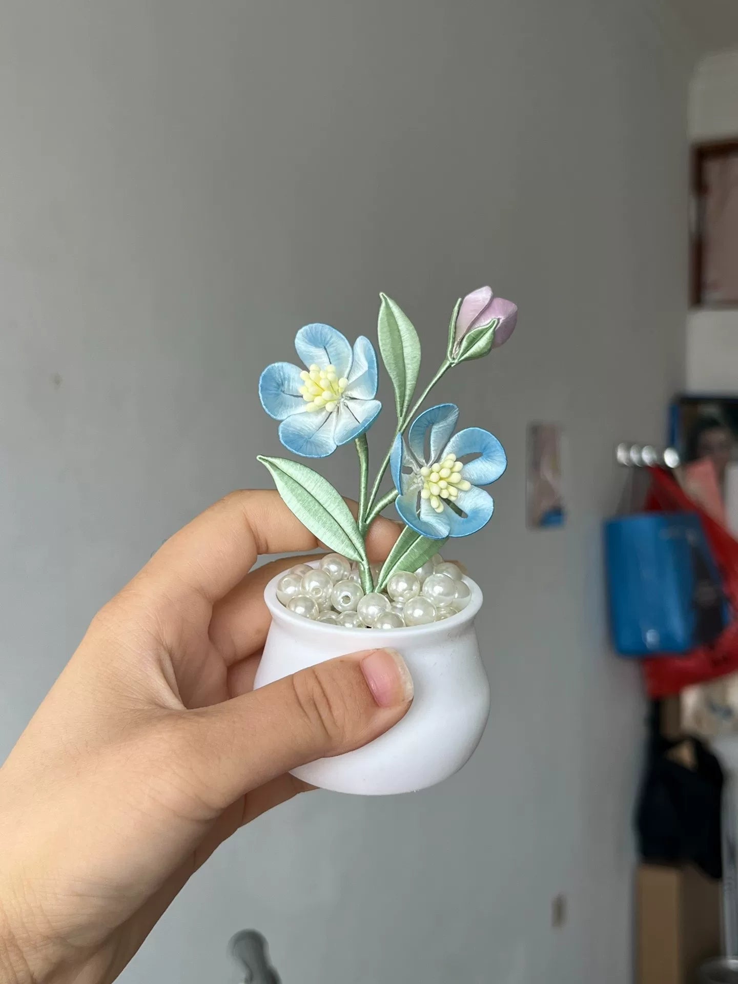 A hand - made Chanhua hair clip with blue flowers, green leaves and a budding flower-3
