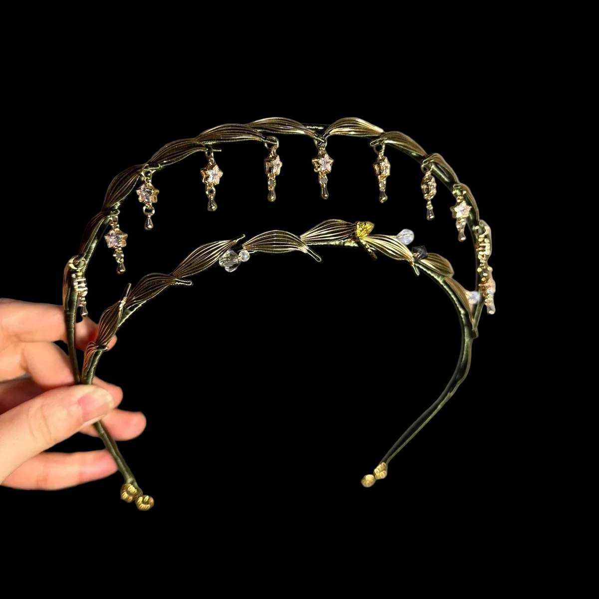 Handcrafted Chanhua Madonna crown featuring dark green thread-wrapped leaves and shimmering crystal star charms.