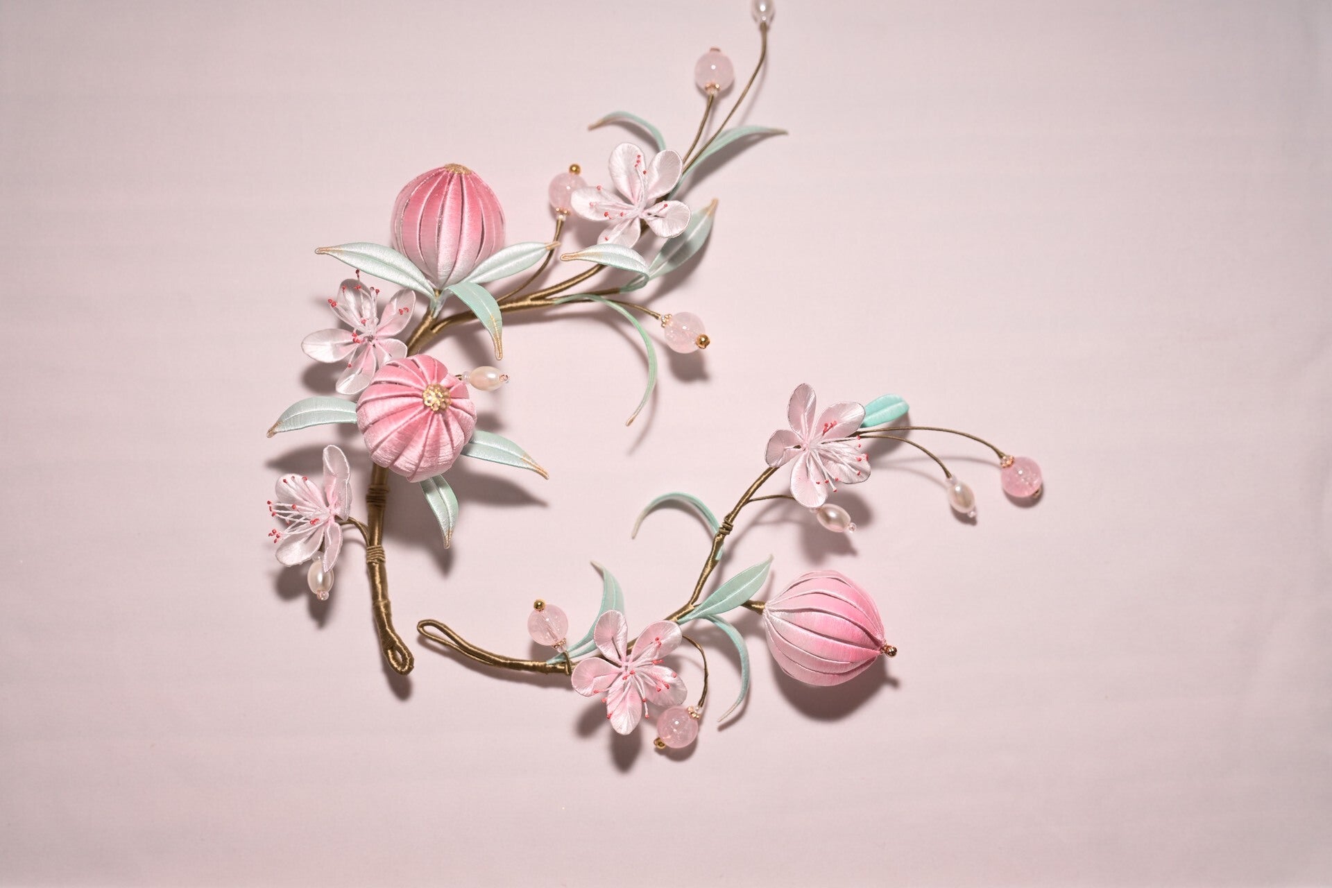 Handmade Chanhua peach blossom hairpins set with pink flowers and leaves on a light background