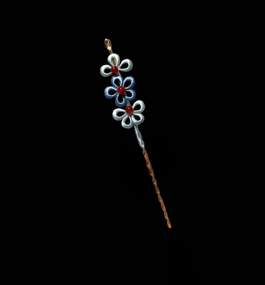 Close-up of delicate blue and silver layered flowers on handmade Chanhua hairpin