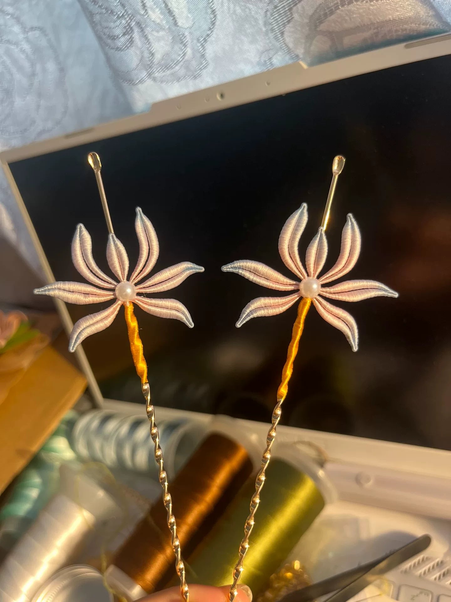 Two handmade Chanhua orchid - patterned ear - pick hairpins held by a hand-3
