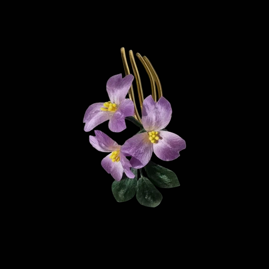 Handcrafted Ronghua violet hair comb featuring soft purple velvet-textured silk petals with yellow stamens and green leaves.