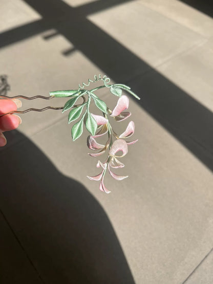 A handmade Chanhua wisteria flower accessory with pink petals and green leaves-3