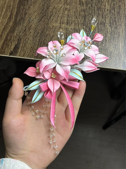 A handmade Chanhua lily hairpiece in pink with leaves and dangling chains on black hair-4