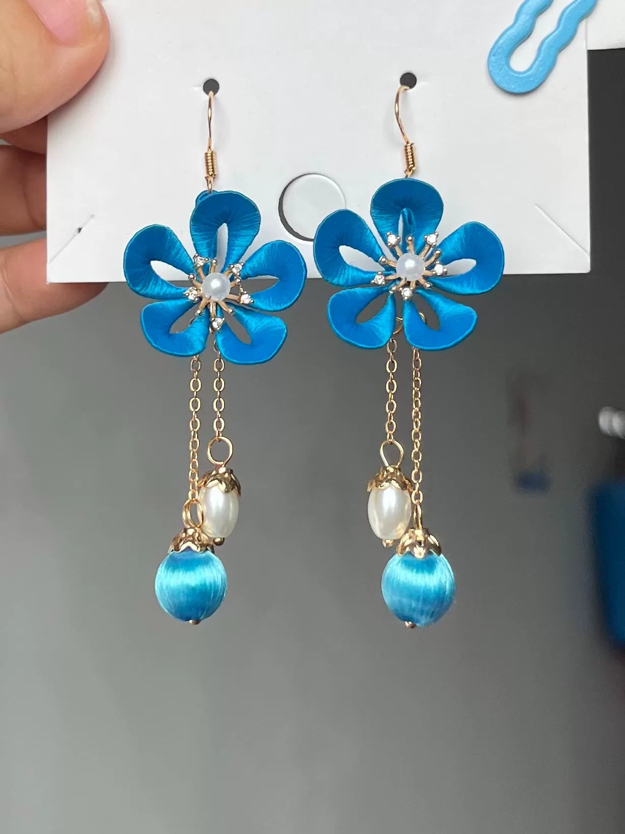 Handmade Chanhua earrings with a pink flower, blue leaves, a golden charm, and a pearl-5