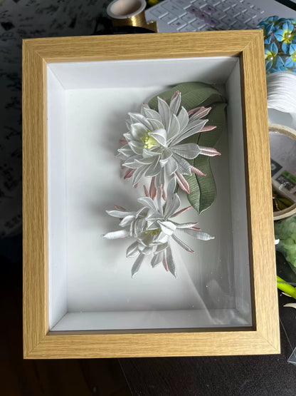 A handmade Chanhua table display in a wooden box with white and pink petals and green leaves-2