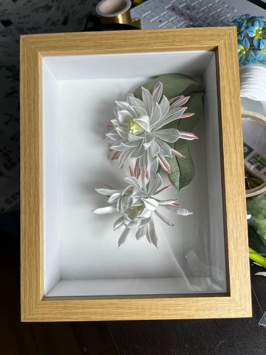A handmade Chanhua table display in a wooden box with white and pink petals and green leaves-2
