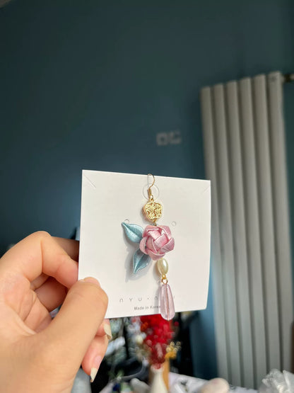 Handmade Chanhua earrings with a pink flower, blue leaves, a golden charm, and a pearl-2