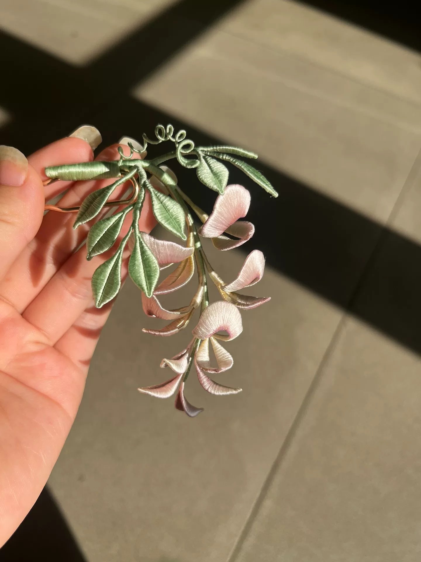 A handmade Chanhua wisteria flower accessory with pink petals and green leaves-2