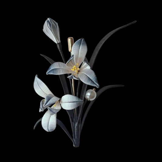 Luxury 3D embroidery floral pin depicting a classical ink-style orchid made with intricate artisanal thread-wrapping.