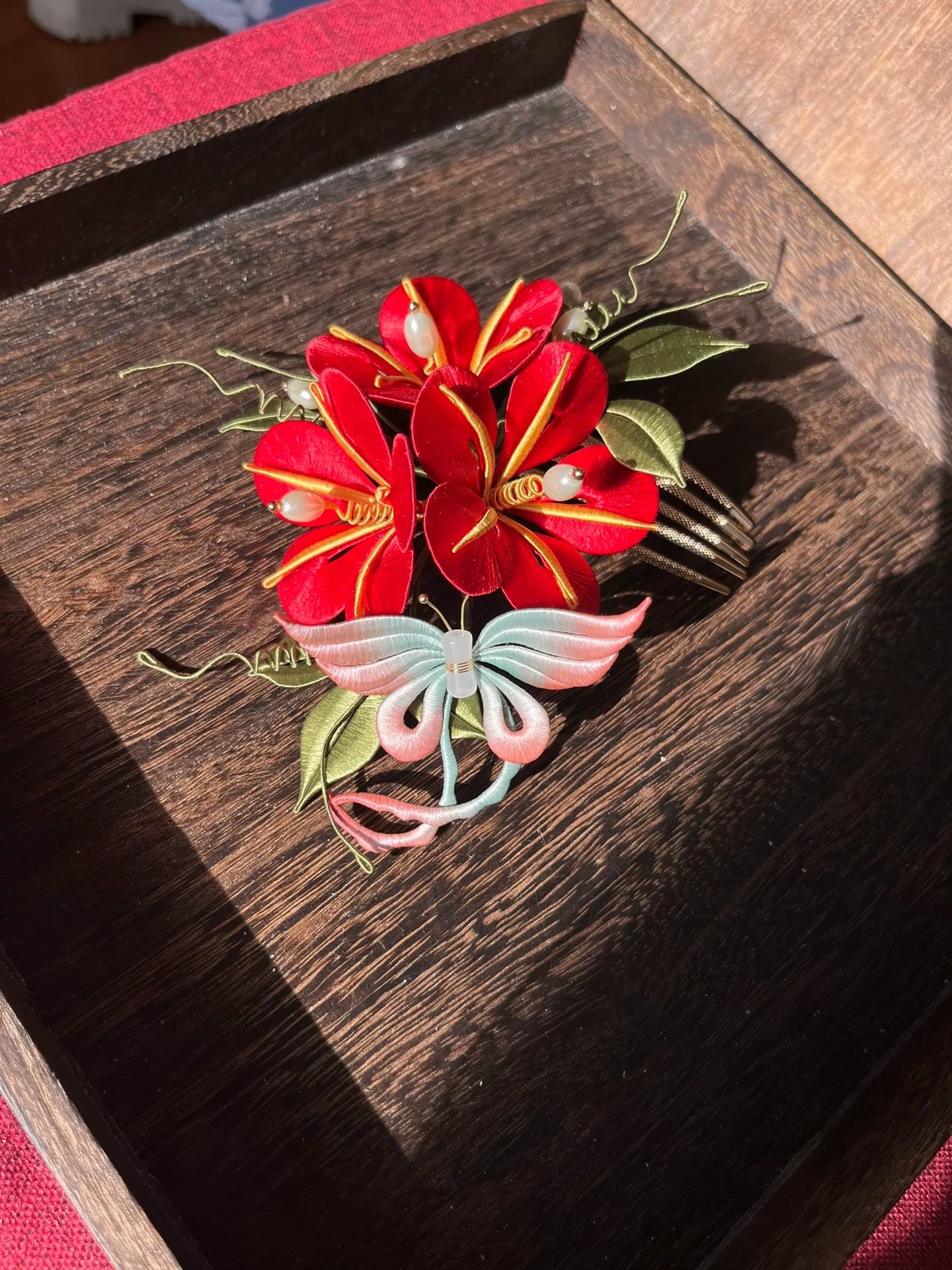 A handmade Chanhua morning glory hairpin with pink flowers and blue - green leaves on a wooden tray-6