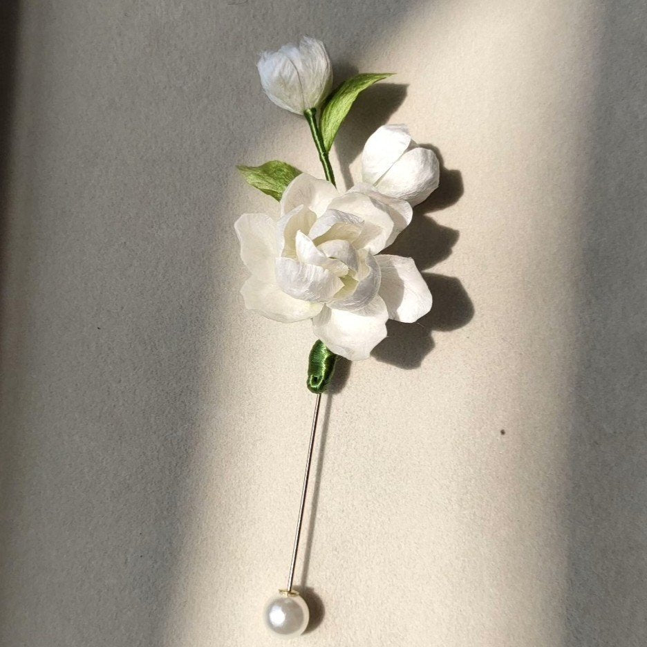 3D silk velvet floral lapel pin depicting blooming jasmine flowers made with traditional artisanal Ronghua techniques.