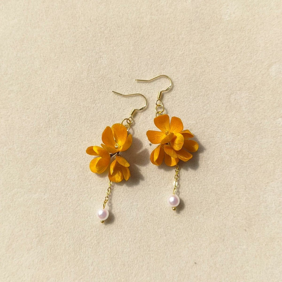 3D silk velvet flower earrings depicting yellow osmanthus clusters made with traditional artisanal Ronghua techniques.