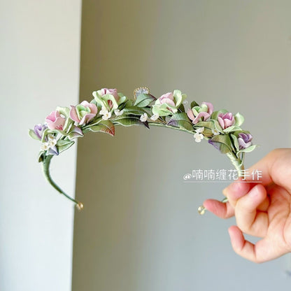 3D thread-wrapped floral crown featuring artisanal roses and a central crystal detail made with Chanhua techniques.
