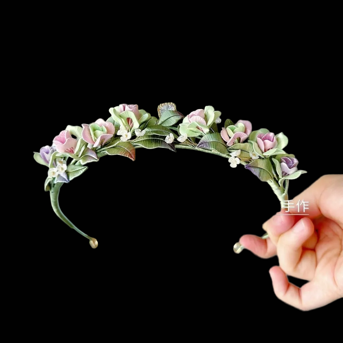 Handcrafted pink and green rose Chanhua tiara with thread-wrapped leaves and small white floral accents.