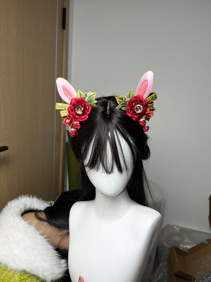 A pair of handmade Chanhua Christmas - style bunny - ear hair clips with red flowers and green leaves, on a mannequin's head-2