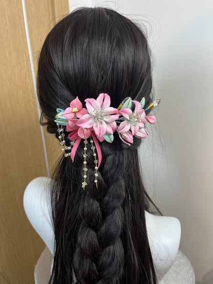 A handmade Chanhua lily hairpiece in pink with leaves and dangling chains on black hair-2