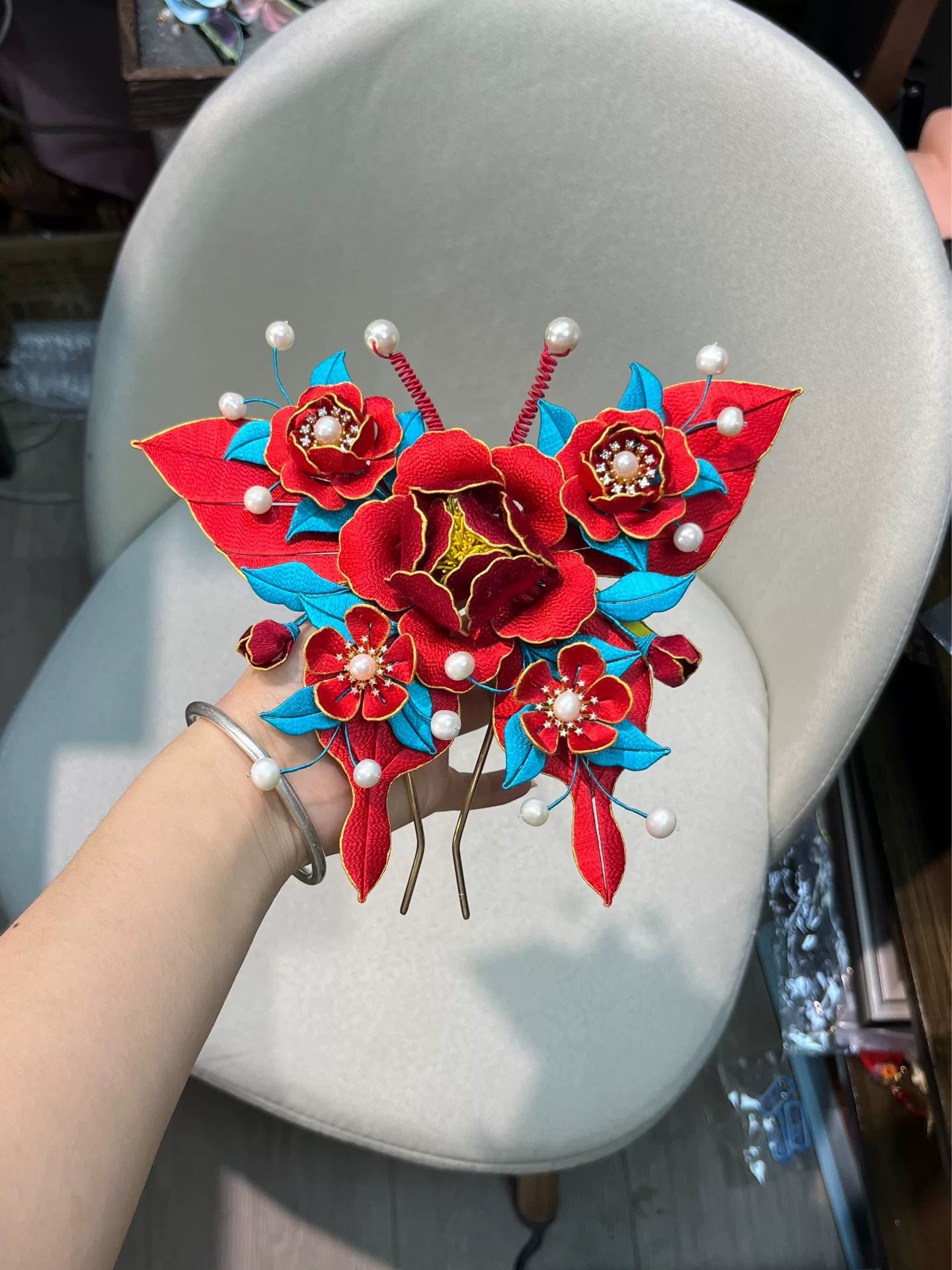 A handmade Chanhua big butterfly hairpin with red flowers, blue leaves and white pearls