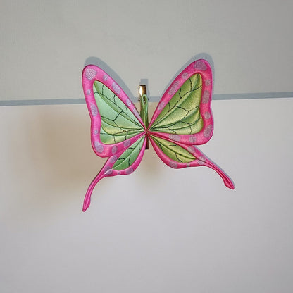Handcrafted Chanhua thread-wrapped butterfly hair clip featuring a pink and green wing design with intricate patterns inspired by ninja aesthetics.
