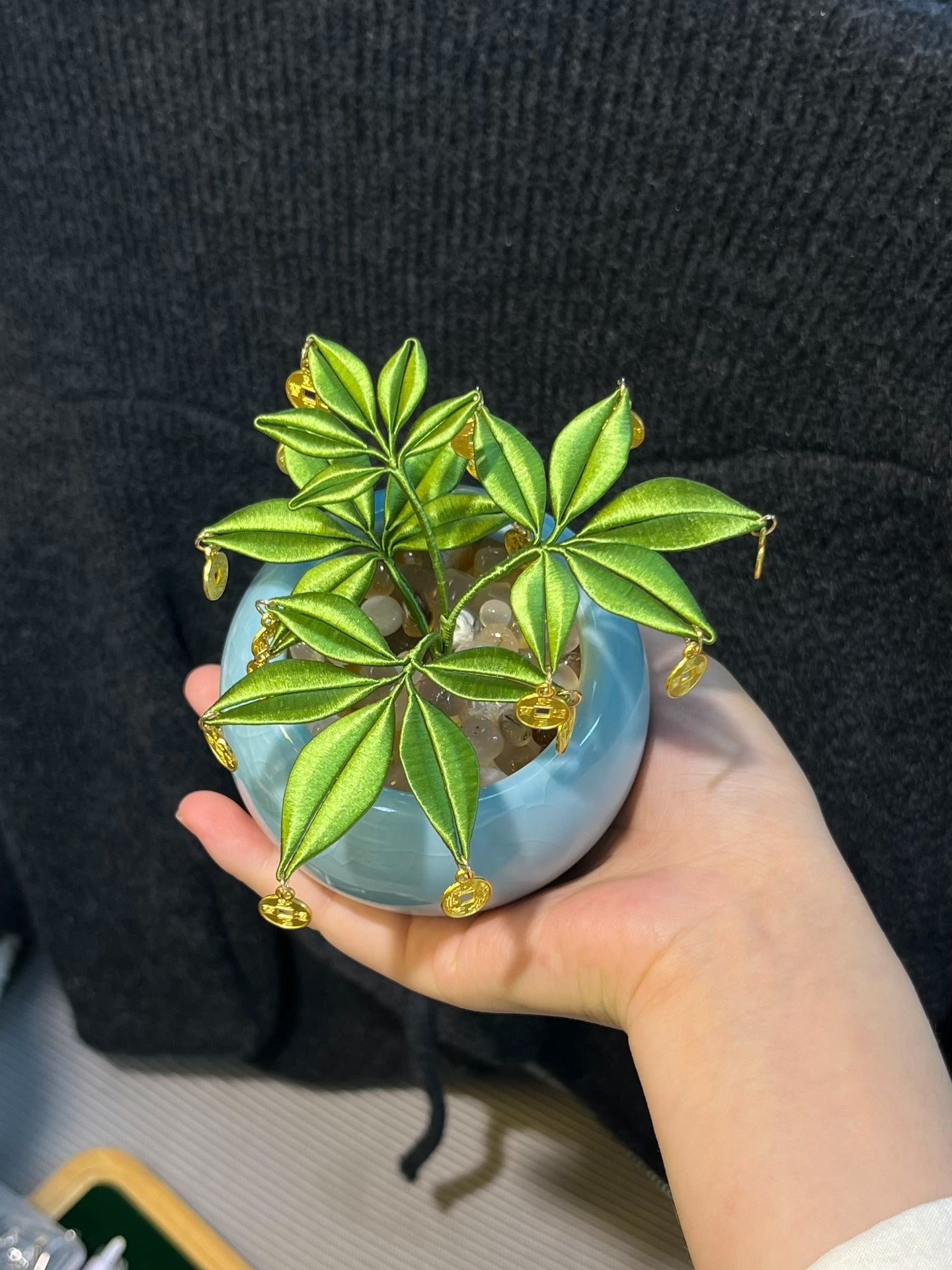 A handmade Chanhua money tree ornament in a light - blue pot with green leaves and golden coins-2