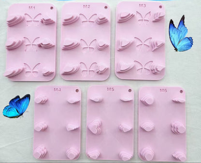 Silicone butterfly and petal wire form templates in pink, shown with finished blue and gold butterfly craft examples and nail art display.