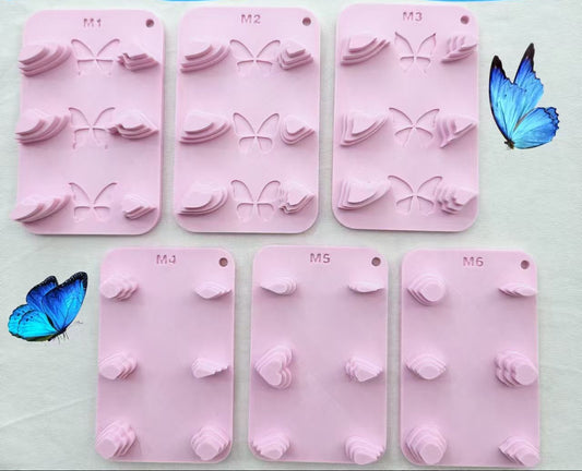 Silicone butterfly and petal wire form templates in pink, shown with finished blue and gold butterfly craft examples and nail art display.
