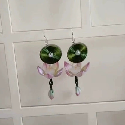 Elegant handcrafted earrings with a lotus and a leaf design, made from Chanhua fabric, photographed against a clean background.