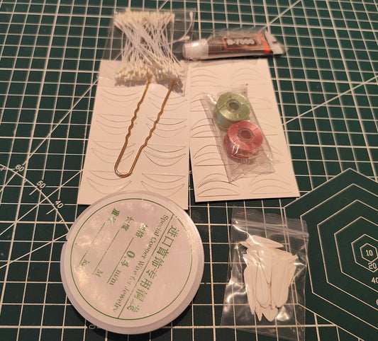 Contents of the Sun Flower Chanhua DIY hairpin kit, including spools of thread, copper wire, a hairpin base, and paper templates on a craft mat.